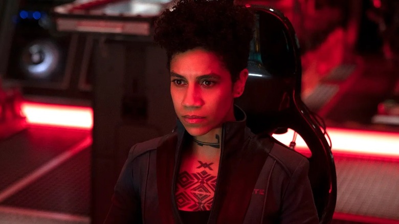Naomi bathed in red light in 