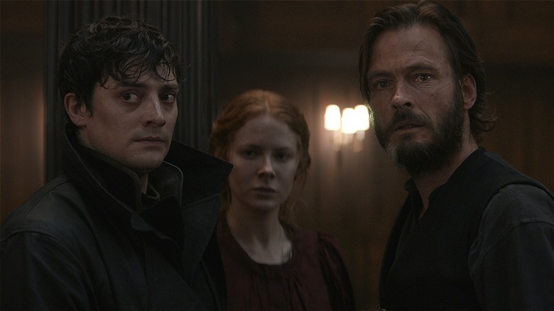 Maura, Eyk, and Daniel turning and looking startled in 1899