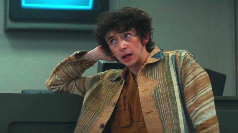 Boy Kavalier in "Alien: Earth" resting his head in his hand casually