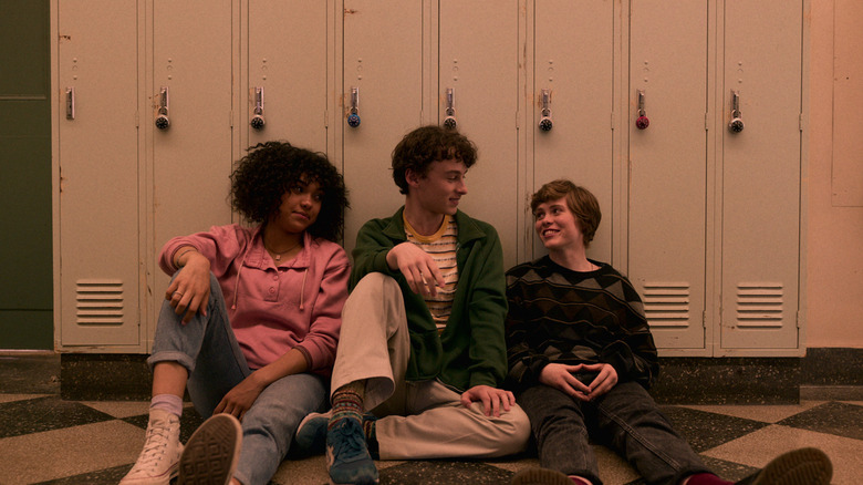 Dina, Stanley, and Sydney sitting with their backs against lockers in "I Am Not Okay With This"