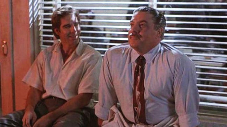 Sam and Al the bartender sitting beside a window on Quantum Leap