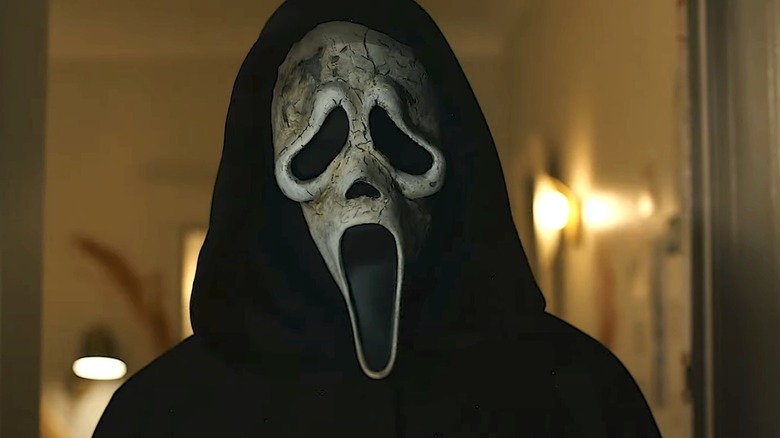 Ghostface with a dirty mask standing in doorway