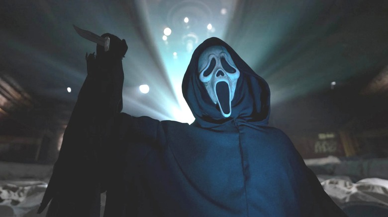 Ghostface holding knife with light behind 