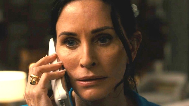 Gale Weathers holding a phone in Scream 6