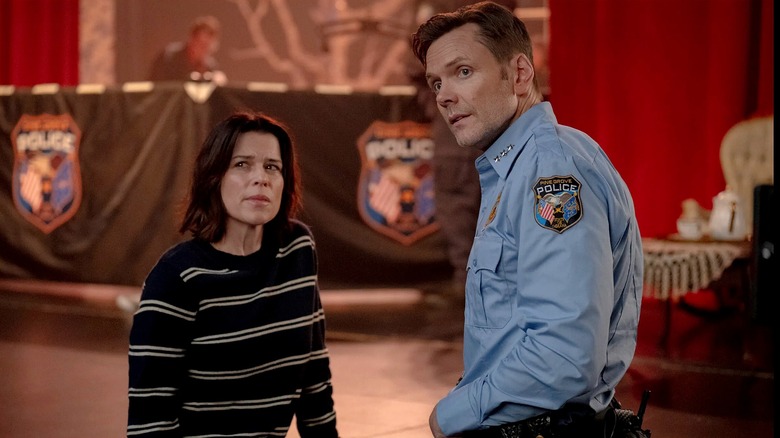 Sidney Prescott-Evans standing with her husband Mark in Scream 7