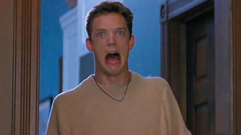 Stu Macher laughing as he walks backwards