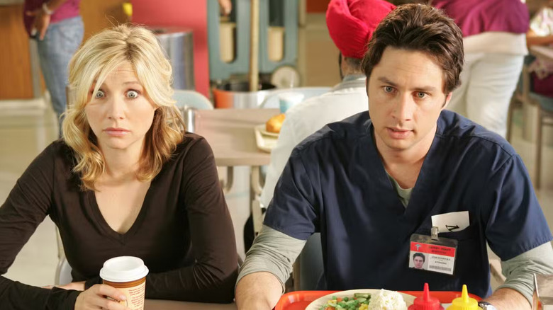 Elliot and JD looking stressed and surprised in the cafeteria on Scrubs