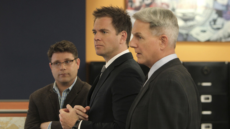 Tyler Elliott next to Gibbs and Tony with his arms folded