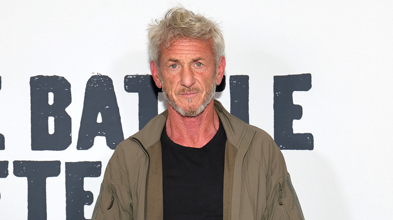 Sean Penn in a brown jacket and black shirt