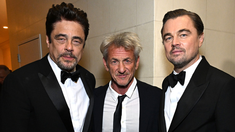 Benecio del Toro, Sean Penn, and Leonardo DiCaprio posing at award ceremony