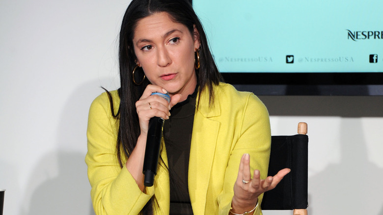 Olivia Milch speaking into microphone 