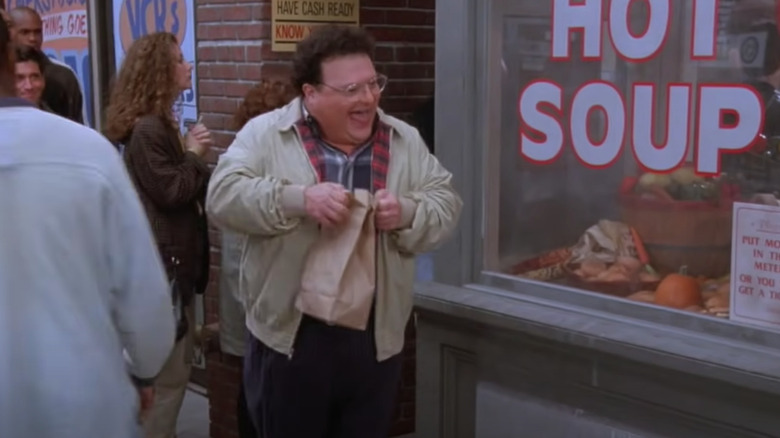 Newman holding a bag