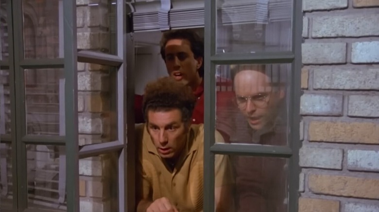 Kramer, Jerry, and George looking out a window in "Seinfeld" (1989-1998)
