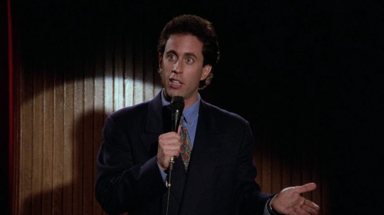 Jerry Seinfeld on stage with a microphone