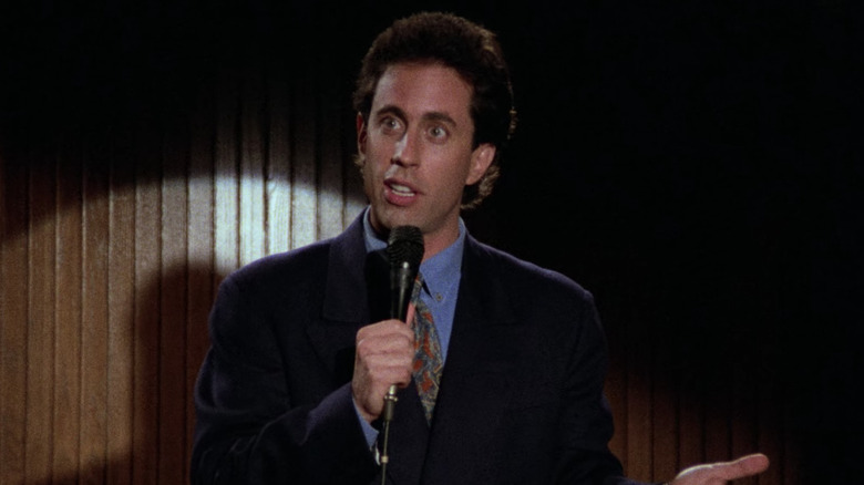 Jerry Seinfeld on stage with a microphone