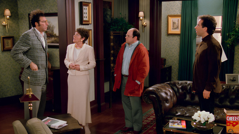 Realtor, George, and Jerry looking at Kramer