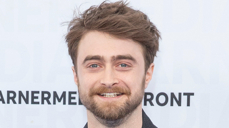 Daniel Radcliffe smiling at a red carpet event