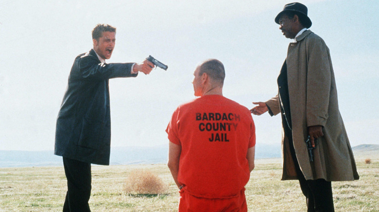 Mills points his gun at John Doe as Somerset watches in "Seven" (1995)