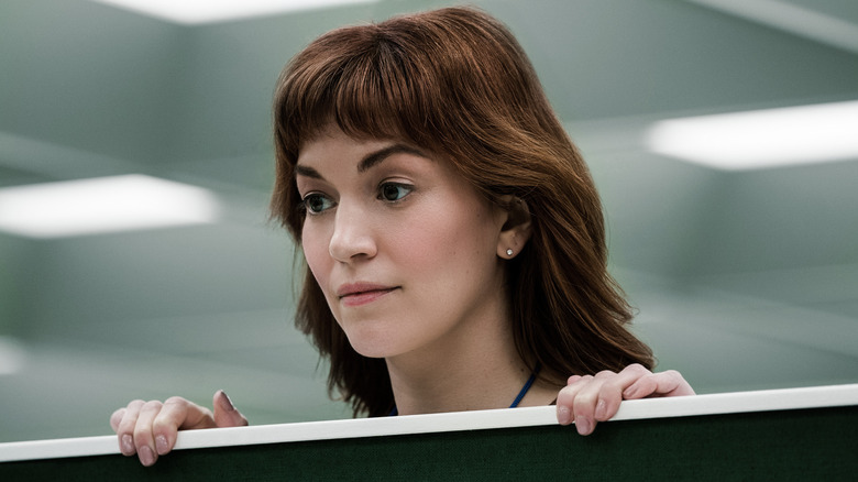 Helly looking over an office cubicle wall