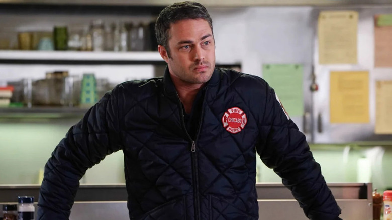 Kelly Severide leaning on countertop