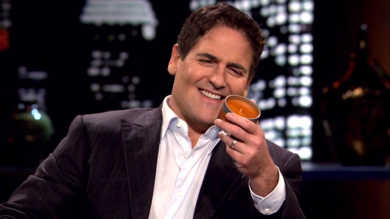 Mark Cuban smiling holding candle