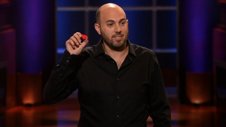 CJ Isakow holding up EyeBloc on Shark Tank