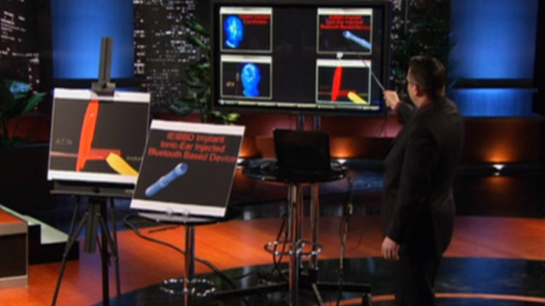 Darrin Johnson showing off graphs of Ionic Ear on Shark Tank
