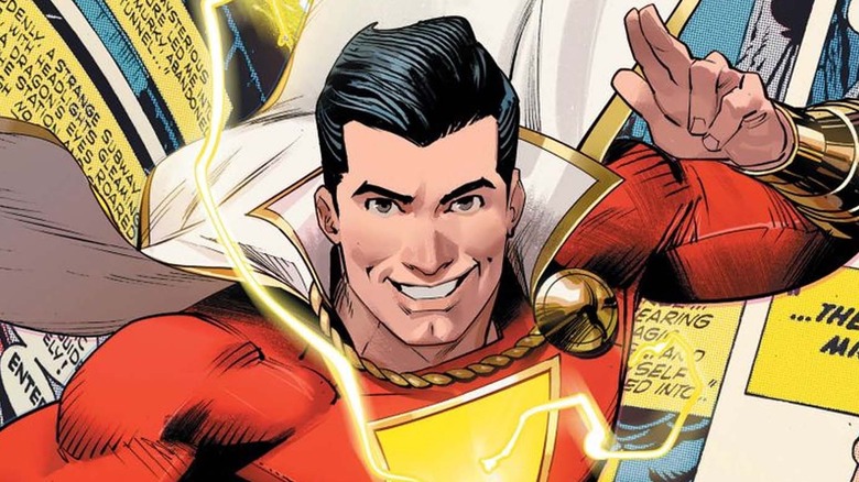 Shazam waving in front of comic book