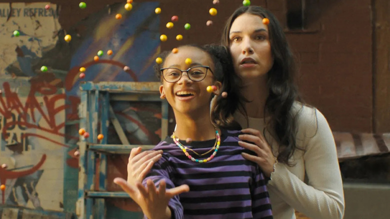 Darla throwing skittles in the air