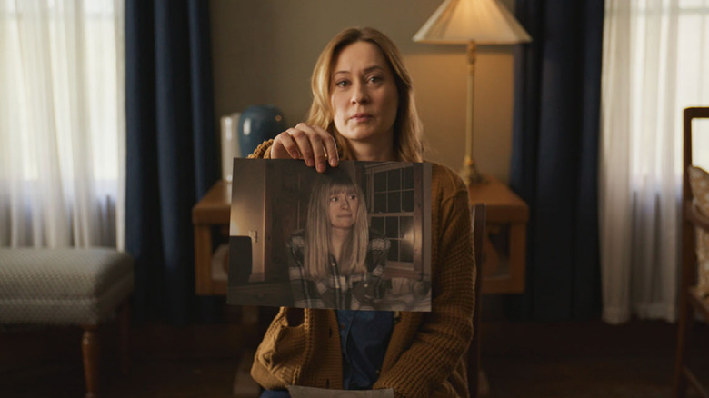 Mia holds a photo of Riley in "Shelby Oaks" (2025)