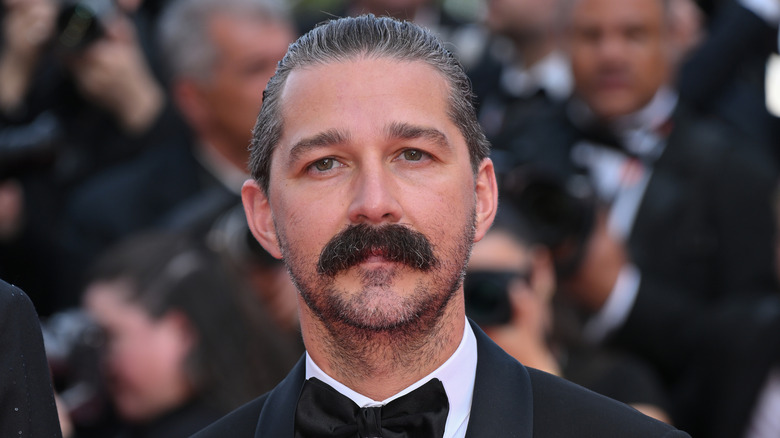 Shia LaBeouf with a mustache in a tuxedo