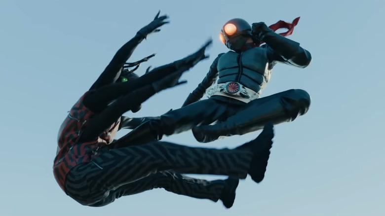 Kamen Rider kicking opponent mid-air