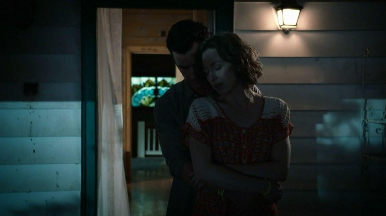 Kevin and Nora embrace on the porch