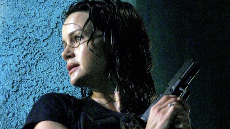 Karen against wall with gun