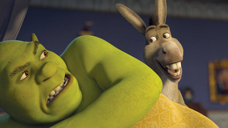 Donkey standing over Shrek while he's in bed