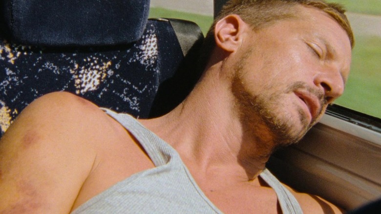 Mikey sleeping on a bus in Red Rocket