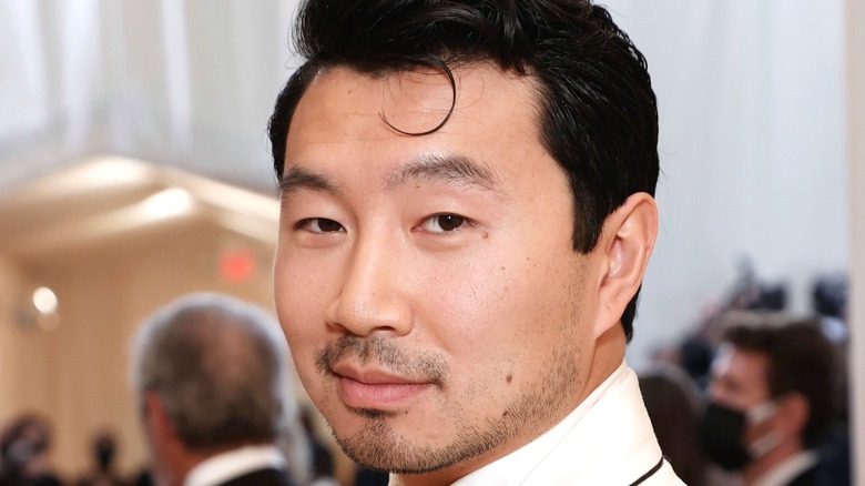 Simu Liu smiling for photographers