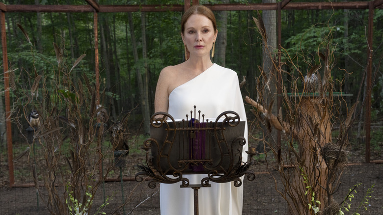 Michaela standing at podium in a white dress