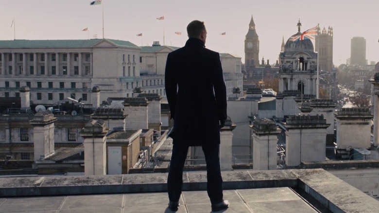 James Bond stands on a rooftop
