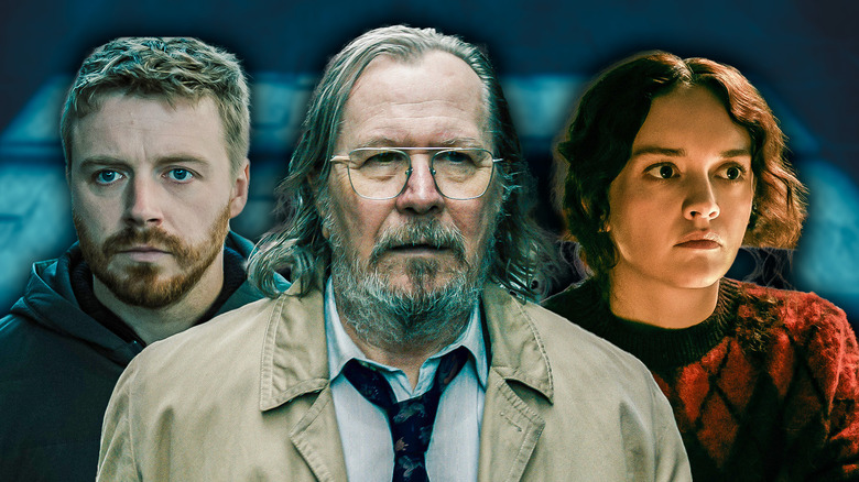 Close-up of Gary Oldman as Jackson Lamb in the center; Jack Lowden as River Cartwright on one side and Olivia Cooke as Sid Baker on the other.