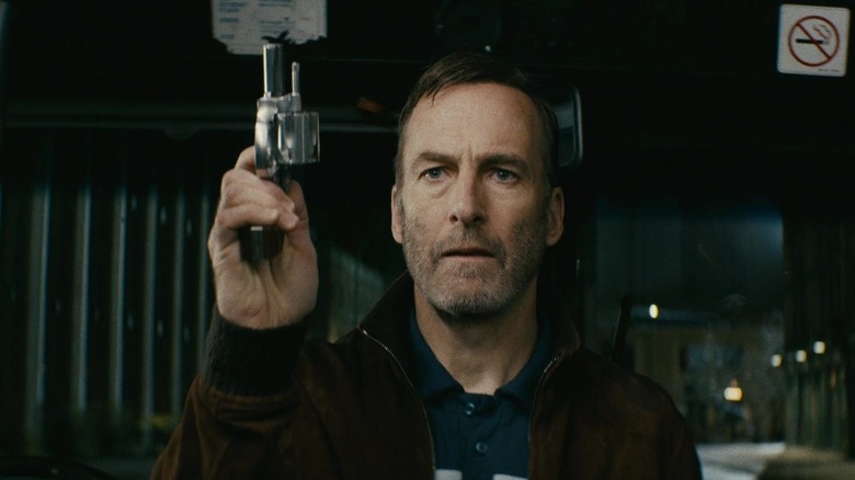 Bob Odenkirk holds gun
