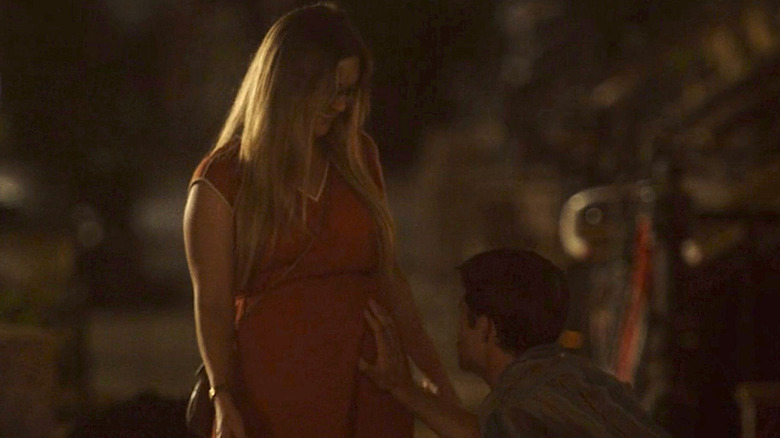 Adam rubs Hannah's pregnant belly