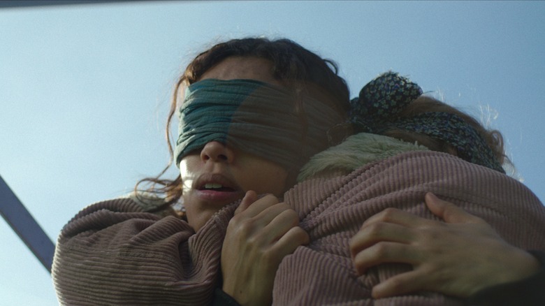 Blindfolded Claire holding Sofia