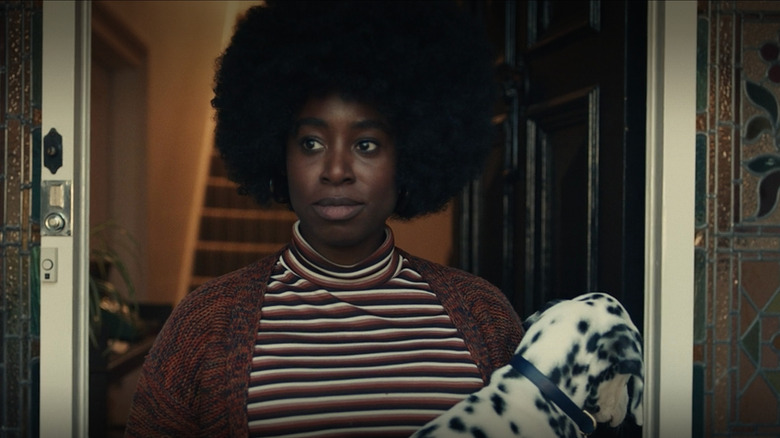 Anita holding Perdita the Dalmatian Cruella