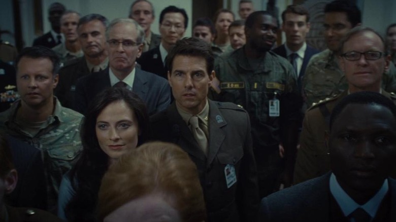 Bill Cage watches news with crowd