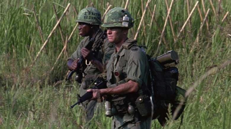 Bubba and Forrest look off to side in jungle