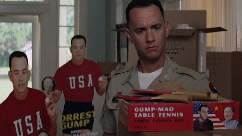 Confused Forrest looks at ping pong paddles