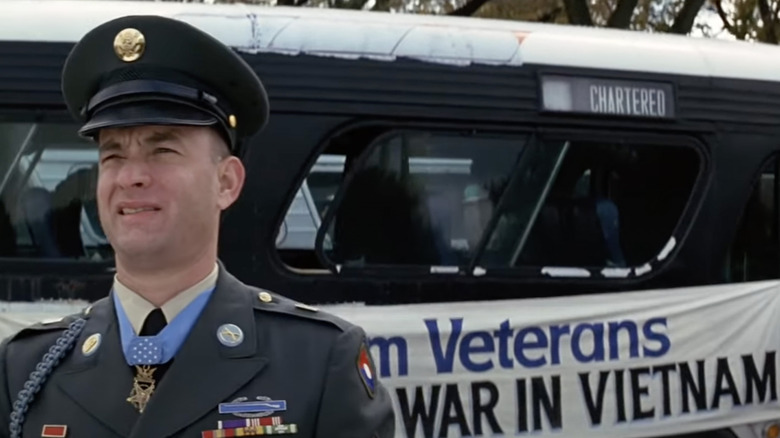 Forrest squints in front of bus