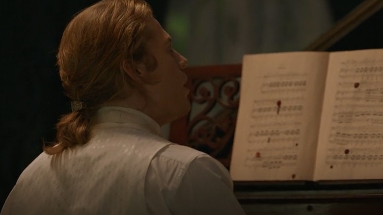 Lestat in front of sheet music