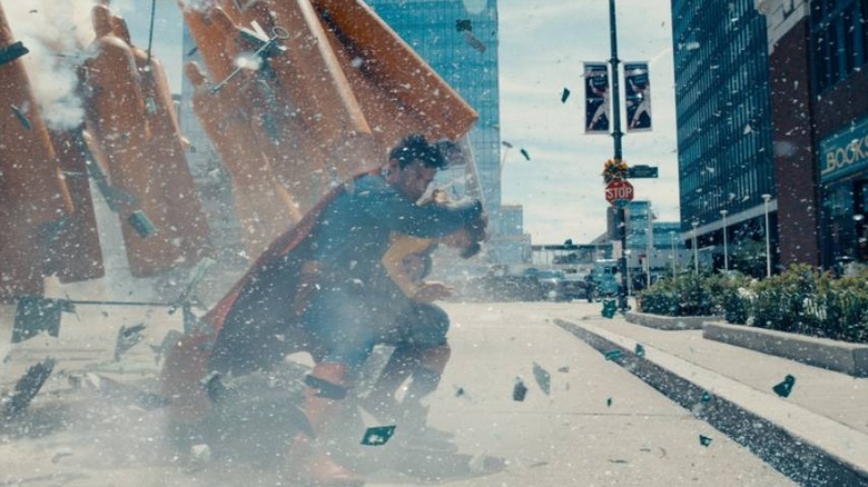 Superman protecting a little girl in Superman (2025)